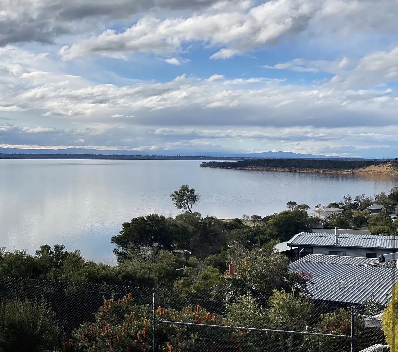 Still water of Lake Victoria and the sandy shoreline at the quiet end of Loch Sport