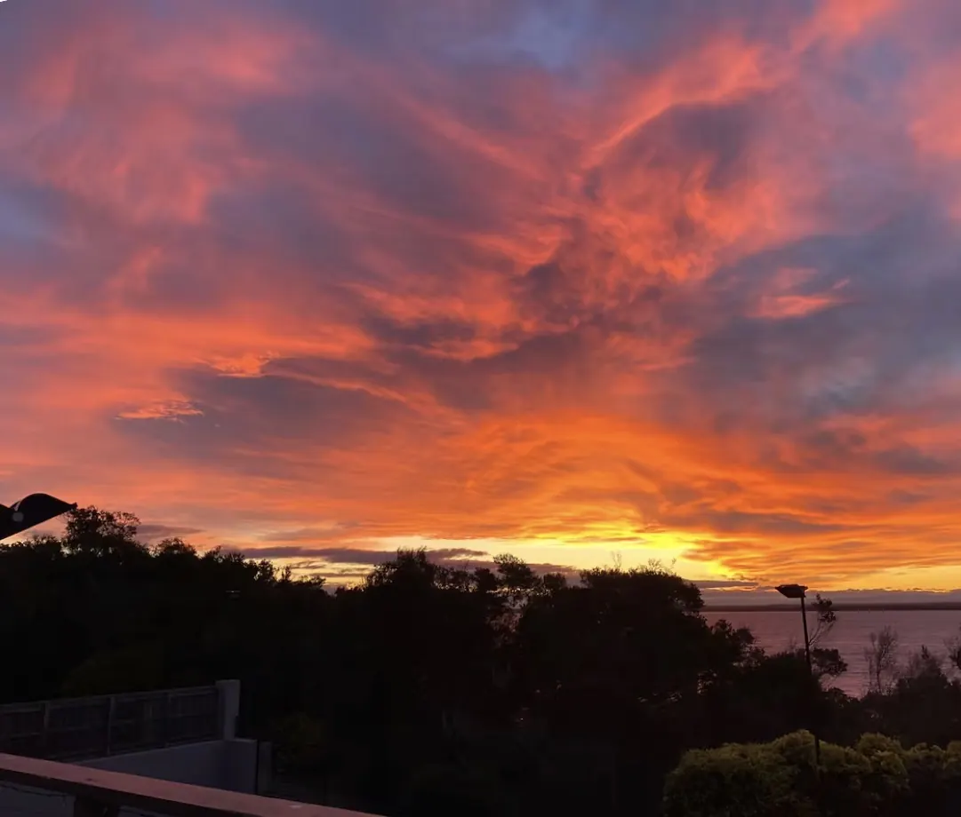 Fiery sunset clouds over Lake Victoria seen from the deck at The Waterfront Loch Sport