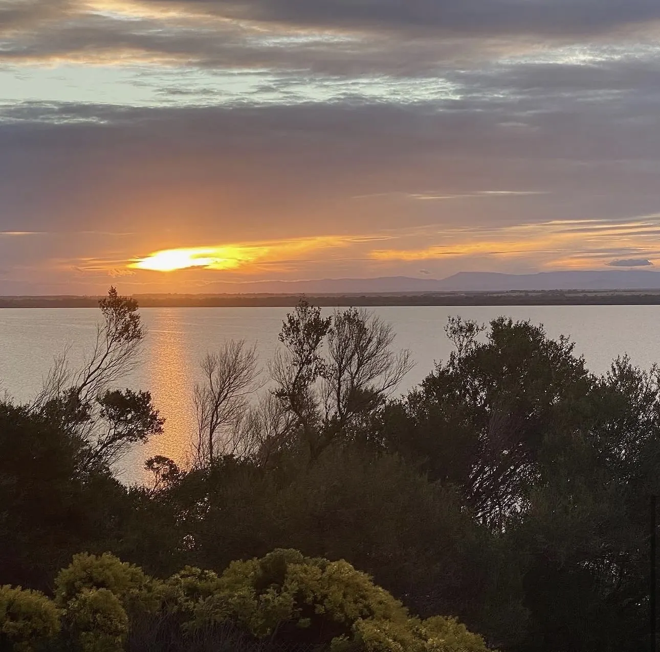 Sunset over Lake Victoria and the distant mountains from The Waterfront Loch Sport