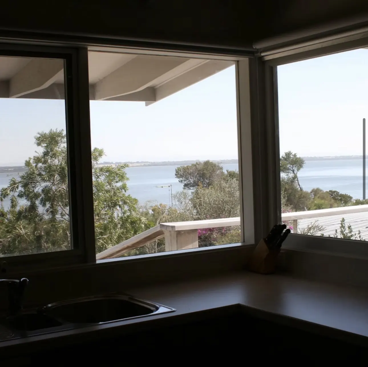Kitchen bench and corner window looking out over Lake Victoria