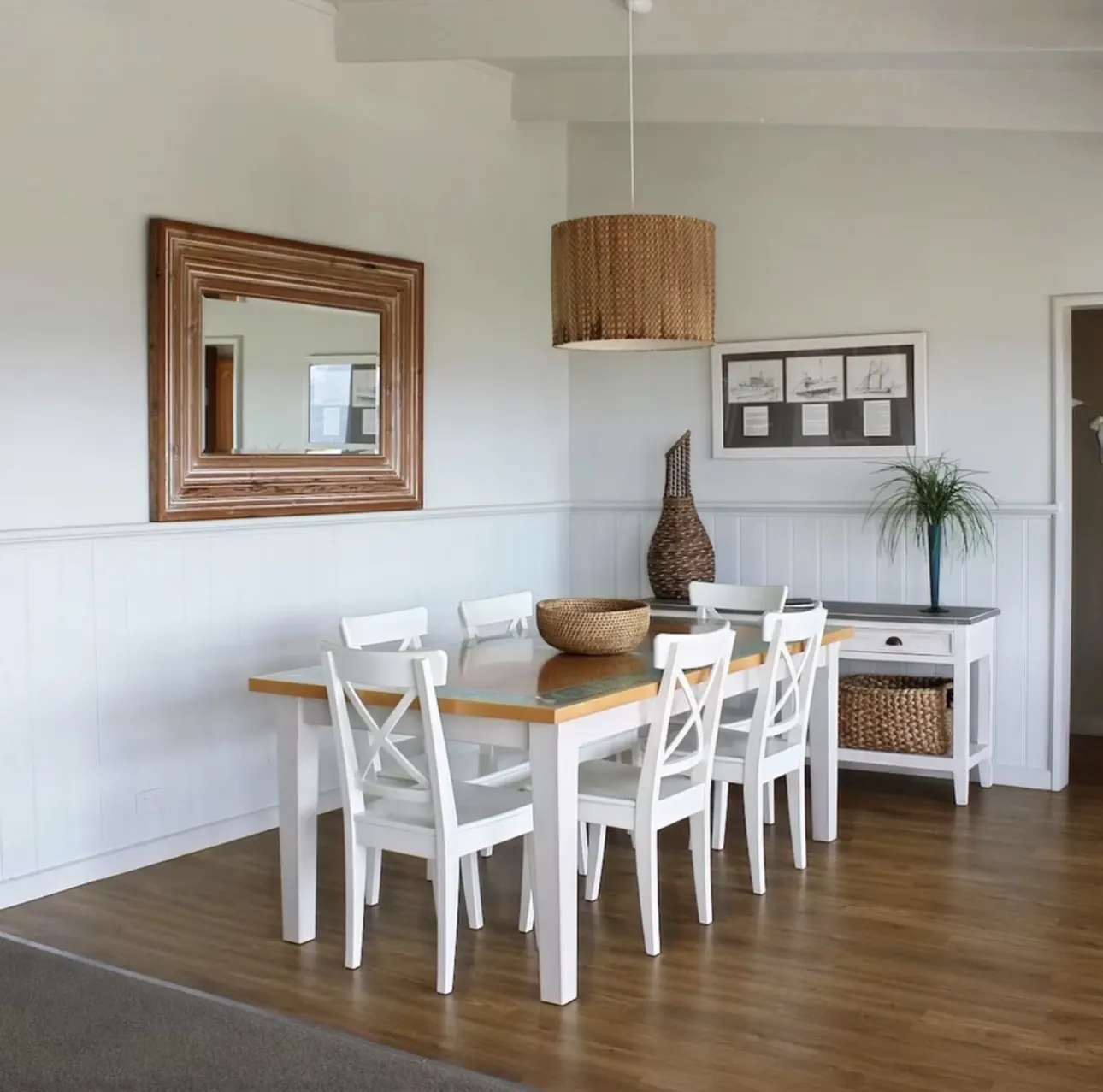 Dining table for six with rattan pendant light in the open plan living area